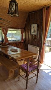 a dining room with a wooden table and chairs at Chalets des Trois Hêtres in Plombières-les-Bains