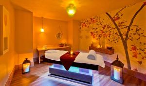 a room with two beds and a table and lights at Titanic Deluxe Lara in Lara