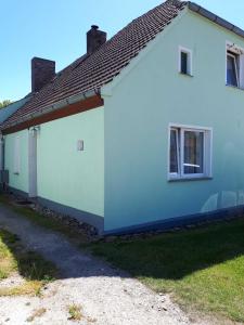 a white house with a brown roof at Haus Ebel in Putgarten