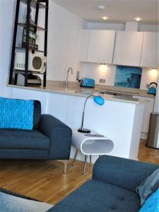 a living room with a couch and a table at Sea, Stay and Relax Away - Stunning, Modern, Home from Home in Newquay