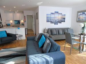 a living room with a couch and a table at Sea, Stay and Relax Away - Stunning, Modern, Home from Home in Newquay