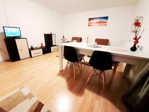 a room with a white table and chairs in it at Casa Maria in Mălîncrav