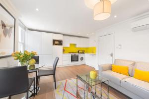 a living room with a white couch and a table at Marylebone - Crawford Street by Viridian Apartments in London