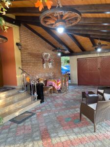 a patio with a table and chairs and a ceiling at Casa cu Flori Moisei in Moisei
