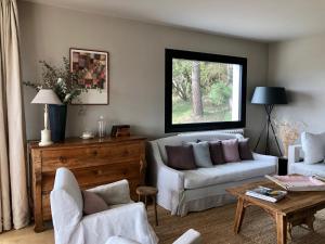 a living room with a couch and a table at Vue exceptionnelle sur lac d'Annecy et Montagnes in Menthon-Saint-Bernard