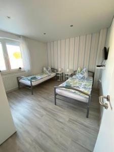 a room with two beds and a window at Ferienhaus Thalia 1 in Übach-Palenberg