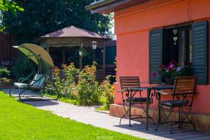 a patio with chairs and a table and a gazebo at Sunset Cottage in Braşov