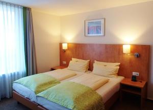 Postel nebo postele na pokoji v ubytování Hotel Mingarden