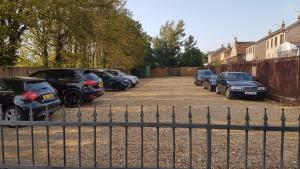 a row of cars parked in a parking lot at The Elm Tree Inn in Wisbech