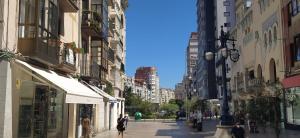 a city street with people walking down the street at Alojamientos Cantíber in Santander