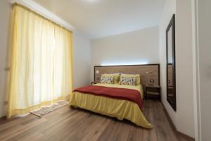 A bed or beds in a room at Le Due Torri