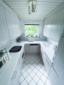a white kitchen with a sink and a window at Ferienwohnung Alte Lahnbrücke in Limburg an der Lahn