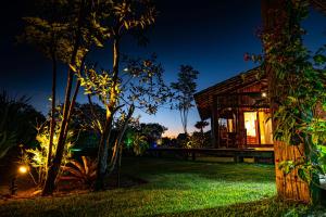 a house at night with lights on the grass at Bahia Soul - Flow Beach House - Taipu de Fora - Península de Maraú in Barra Grande