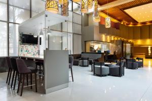 a restaurant with chairs and a bar in the lobby at Crowne Plaza San Jose La Sabana, an IHG Hotel in San José