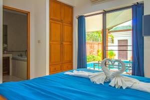 a bedroom with a bed with two towels on it at VIEW TALAY VILLAs POOL 155, JOMTIEN BEACH, PATTAYA in Jomtien Beach