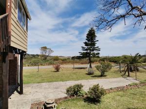 a house with a tree on the side of it at Kayser's Sea Breeze in East London