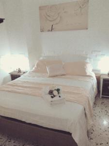 a white bed with a tray with flowers on it at vacanza nel salento1 in Matino