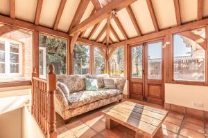 a living room with a couch and some windows at Chestnut Cottage - Stunning Countryside Views! PARKING, 4 BED, 3 BATHROOMS in White Waltham