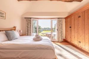 a bedroom with a bed and a large window at Chestnut Cottage - Stunning Countryside Views! PARKING, 4 BED, 3 BATHROOMS in White Waltham