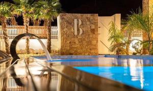 a swimming pool in front of a building with a fence at Espacio Botavara in San José