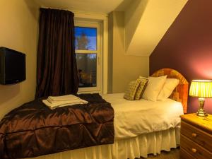 Ένα ή περισσότερα κρεβάτια σε δωμάτιο στο Craglands guest house