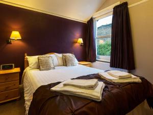 a hotel room with a bed with towels on it at Craglands guest house in Keswick