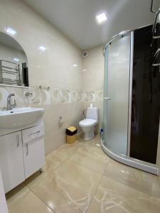 a bathroom with a shower and a sink and a toilet at Апартаменти Золота Баня 5 in Skhidnitsa +18 photos