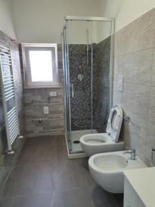 a bathroom with a shower and a toilet and a sink at La villetta vista mare in Bisceglie +17 photos