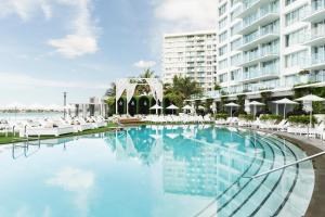 a large swimming pool in front of a large building at Mondrian South Beach in Miami Beach