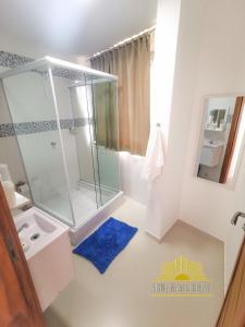 a bathroom with a shower and a blue rug at SUN7 in Morro de São Paulo