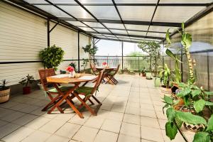 an outdoor patio with tables and potted plants at Delta Hotel in Sevastopol