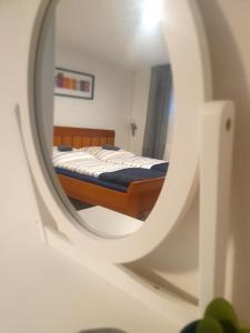 a bedroom with a bed in a mirror at Gemütlich ruhig und zentral durch Bahnhof in Bordesholm