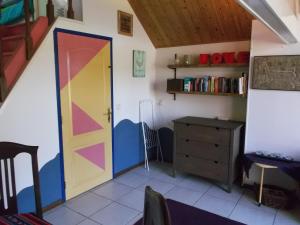 a room with a colorful door and a desk at Holiday Home Achterbos in Sint-Oedenrode