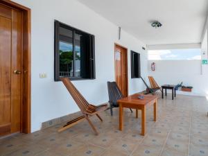 a room with chairs and a table and a window at Hotel Casa Poblana in Bacalar