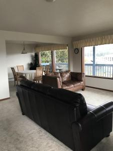 a living room with a black couch and a table at Nordic House in Petersburg