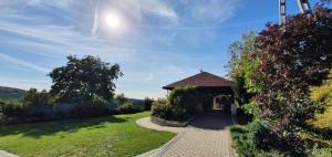 a gazebo in a garden with a pathway at Skalny Widok in Hucisko