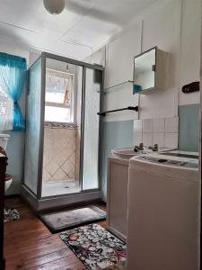 a kitchen with a window and a sink and a refrigerator at Kayser's Sea Breeze in East London