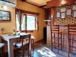 a kitchen with a table and chairs and a brick wall at Apartman IVANA in Vrdnik +24 photos