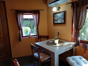 a dining room with a table and a window at Apartman IVANA in Vrdnik
