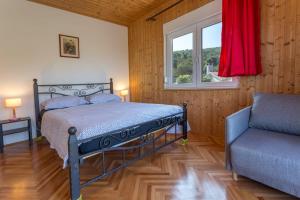 a bedroom with a bed and a window and a chair at Holiday Home Antonija in Stari Grad