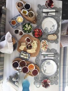 a table topped with plates and bowls of food at Cunda Adali Pansiyon in Ayvalık