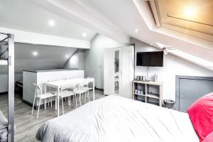 a bedroom with a bed and a table and chairs at The Anfield Rooms in Liverpool