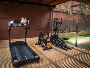 einen Fitnessraum mit zwei Heimtrainern und einem Laufband in der Unterkunft Hotel Lomas 10 in Medellín