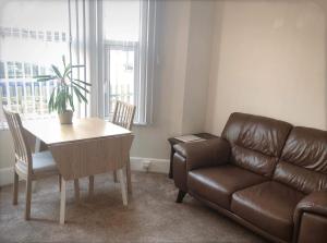 a living room with a couch and a table and a chair at Richmond Luxury flat Fabulous location in Southend-on-Sea