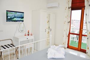 a white bathroom with a sink and a mirror at Relais Bellavista B&B in Casalnuovo di Napoli +33 photos