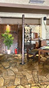 a patio with a wooden table and a bench at Hotel Olimpija plus in Herceg-Novi