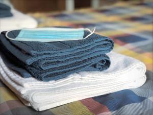 a stack of towels with a mask on top of them at Richmond Luxury flat Fabulous location in Southend-on-Sea