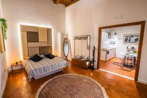 a bedroom with a bed and a table and a mirror at Vinto House Salerno Old Town in Salerno