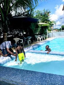 班珠爾的住宿－Woodpecker Resort Hotel，一群人在游泳池玩耍