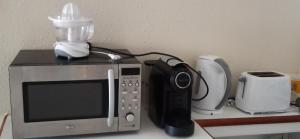 a microwave sitting on a table with a blender at Best Sea View Monte Gordo in Monte Gordo